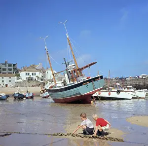Sandbank: Two boys in the harbour, St Ives, Cornwall