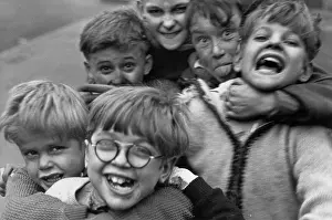 Excited: Six boys having fun in the street