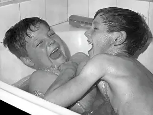 Tickling: Two boys larking about in the bath