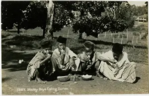 Smelly: Boys in Malaysia eating Durian Fruit