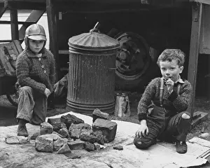 Two boys with pile of rocks