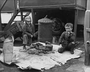 Dustbin: Two boys with pile of rocks