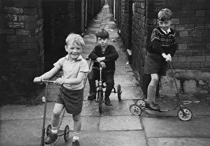 Scooter: Three boys playing in an alleyway