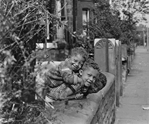 Three boys playing in a front garden
