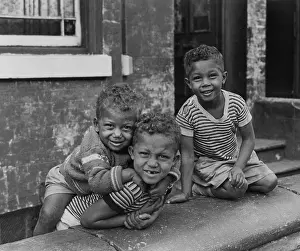 Stripy: Three boys playing in a front garden