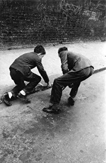 Gutter: Two boys playing in the gutter, West London