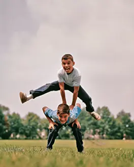 Pre Teen: Boys Playing Leap Frog One Jumping over The Other's