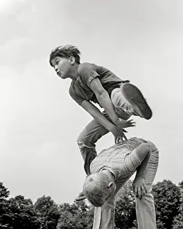 Leapfrog: Two Boys playing Leapfrog One Vaulting over the