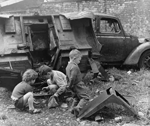 Junk: Three boys playing near abandoned vehicles