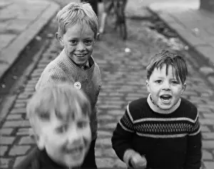 Cobblestones: Three boys playing in the street