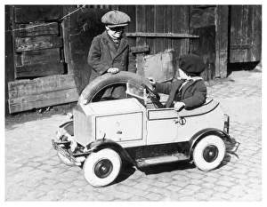 Underage: Boys playing with toy car, 1930s