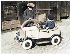 Underage: Boys playing with toy car, 1930s