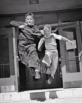 Classmates: Two Boys Running Jumping Out the Doors of Elementary