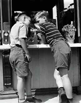 Straws: Boys sharing a soda with two straws leaning on