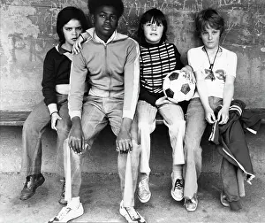 Plimsolls: Four boys sitting on a bench