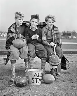 Footballs: Three Boys Sitting on Bench Wrapped in Blanket