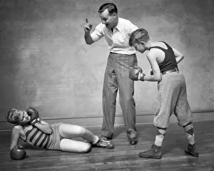 Pugilism: Two Boys Sparring Punching Boxing one Boy Knocked