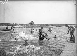 Werian: Boys swim in a pool of water
