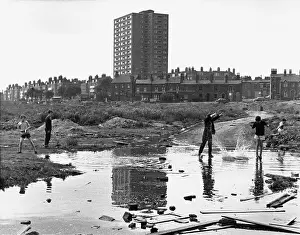 Splash: Boys throwing rocks into puddles - Manchester 1966