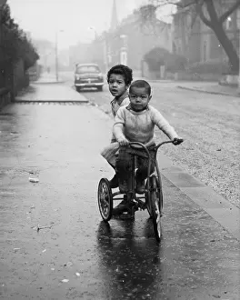 Trike: Two boys on a tricycle