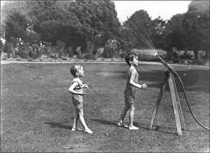 Privileged: Two boys with a water hose in a Devon garden