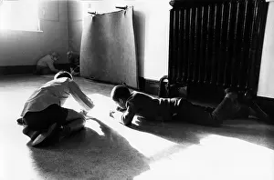 Bleached: Boys work on the floor in an empty classroom