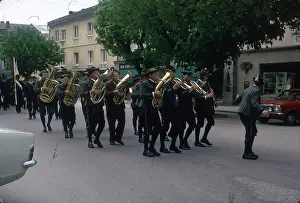 Woodwind: Brass band marching along a street