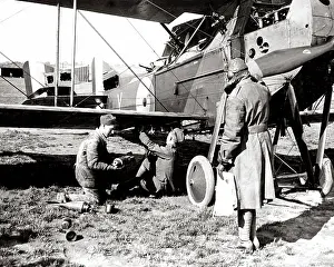 Arming: British airmen arming a plane with bombs, WW1