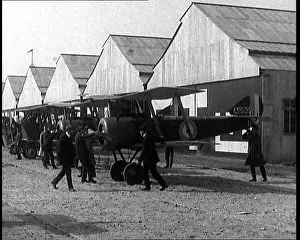 Hangars: British Biplane Fighters Being Moved From Their