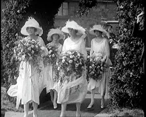 Bridesmaids: British Bridesmaids Walking Through A Flowery
