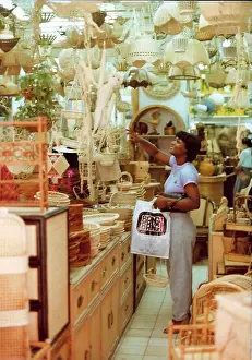 Lampshades: British Caribbean woman points to an item, novelty shop, Hon