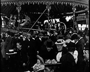 Milling: British Fairground Ride Spinning Round As People
