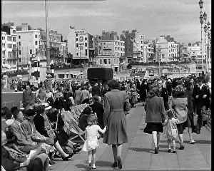 Deckchairs: British Holidaymakers Walking Along the Promenade