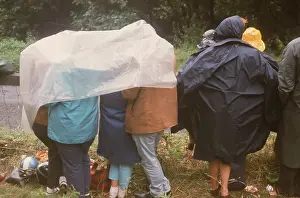 Huddled: The British at Leisure series -- rainy day