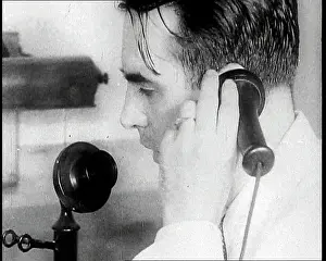 Candlestick: A British Man Holding a Candlestick Telephone