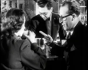 Cocktail: A British Man Talking to a Woman as She is