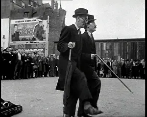 Nineteen: Two British Men in Suits and Hats Dancing in
