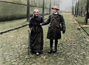 Cobblestones: British padre with elderly woman, Western Front, WW1