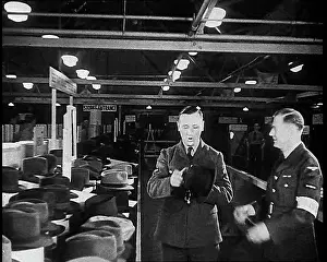 Choosing: British Soldier Choosing A Hat For His Journey Home
