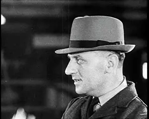 Choosing: British Soldier Choosing A Hat For His Journey Home