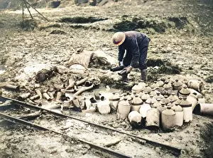 Jugs: British soldier cleaning up debris, Western Front, WW1