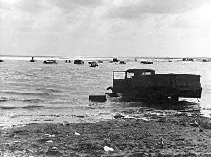 Fore: British trucks on the beach at Dunkirk, 1940