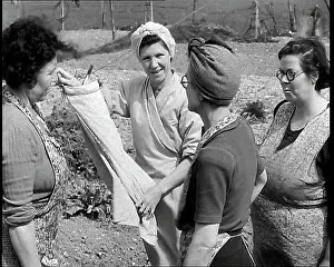Aprons: Four British Women Wearing Aprons Talking By