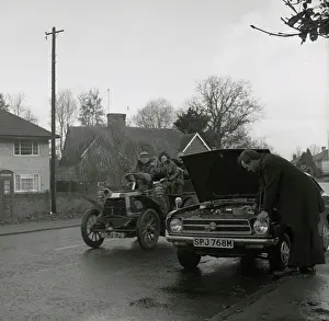 Overtaking: Broken down modern car overtaken by veteran model