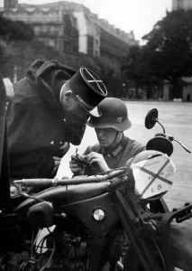 Helps: Broken down motorcycle on the Champs-Elysee in Paris, 1940