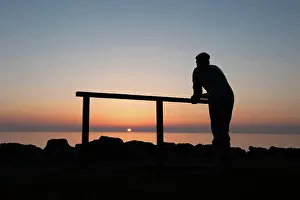 Thoughtful: Bronze statue of fisherman watching the sunset, Port William