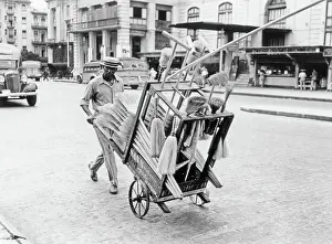 Pal001: Broom Vendor Looking at Camera Pushing his Cart on Stre