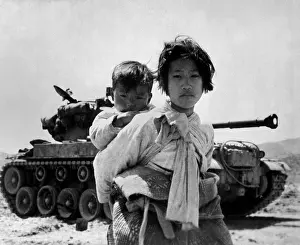 Stalled: With her brother on her back, a war weary Korean