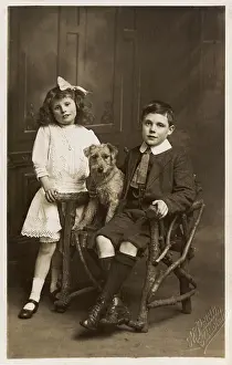 Stiff: A Brother and Sister posing with their pet dog