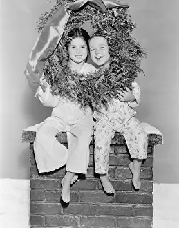 X Mas: Brother and sister sitting on a chimney